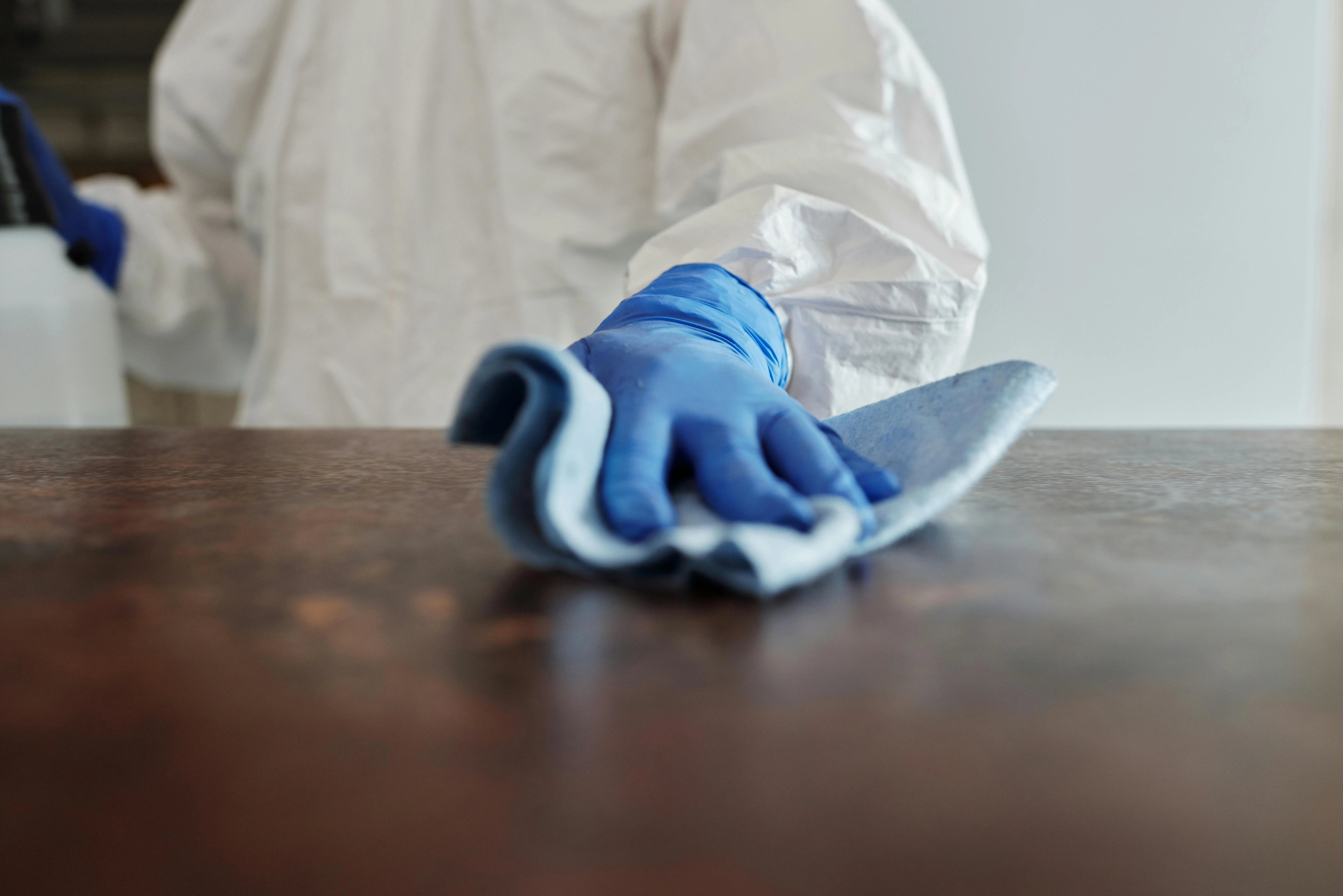 Janitorial staff sanitizing a surface
